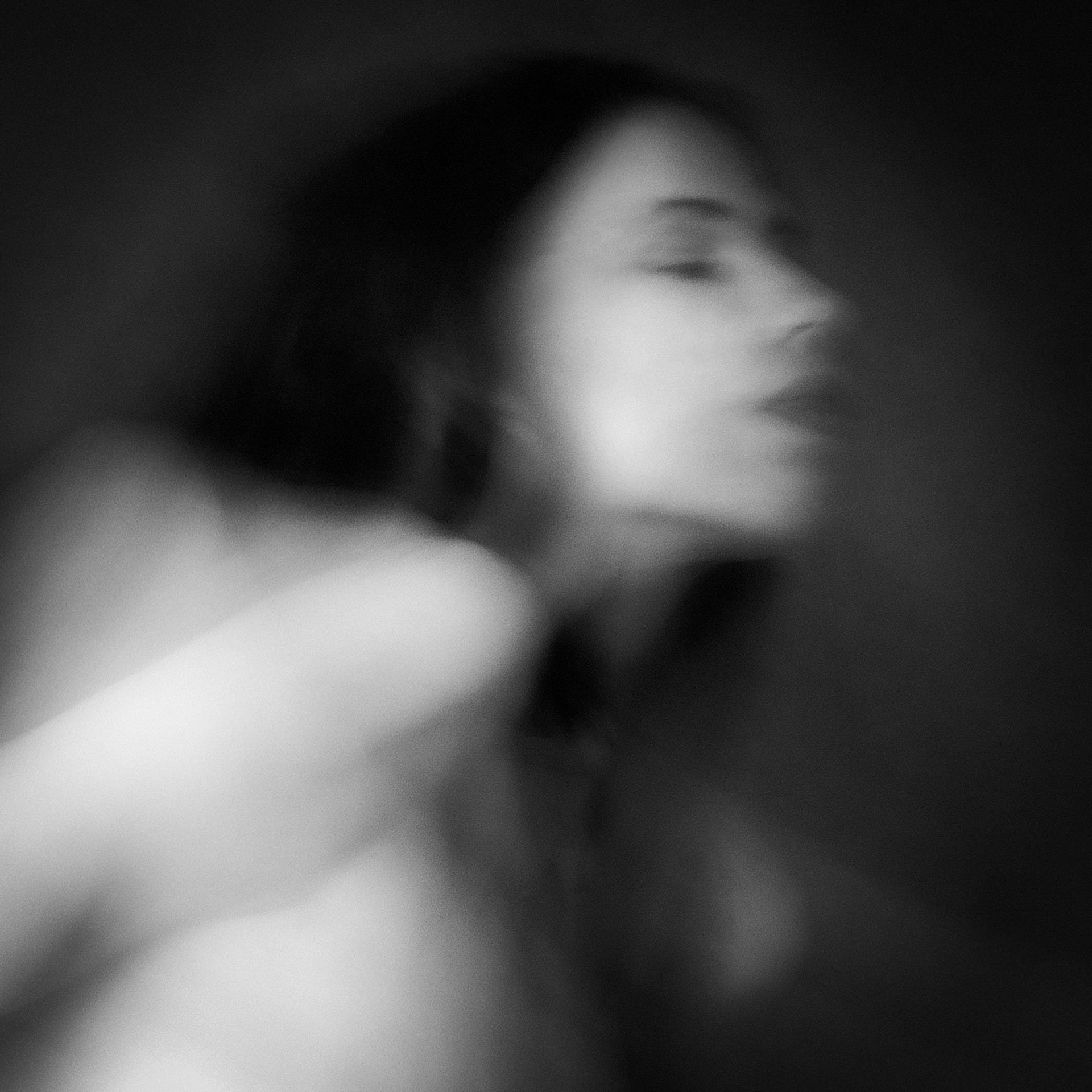 Abstract black-and-white portrait of a woman in motion, with blurred lines and soft focus, by Jerome Art Photography.