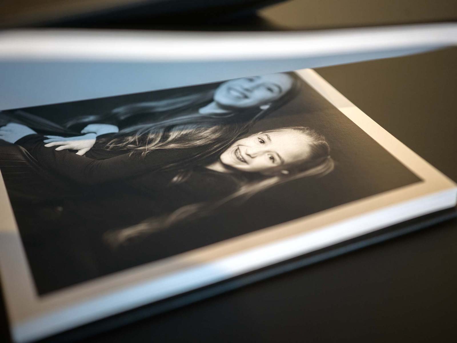 Black-and-white portrait printed on cotton rag paper with visible texture and clean white border.